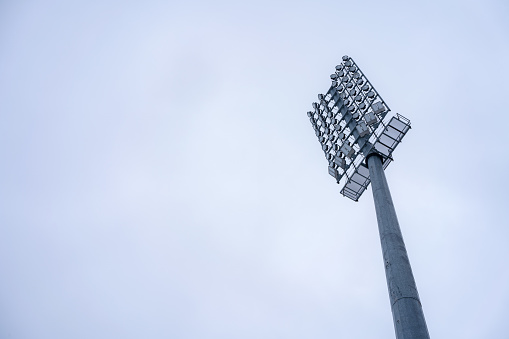 Stadium light tower against the sky with copy space