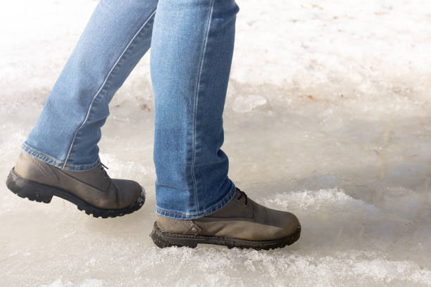 istock man walking on ice in the park. 1478163515