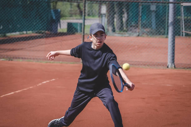 istock Skillful young tennis player making a save in hardcourt 1478165444