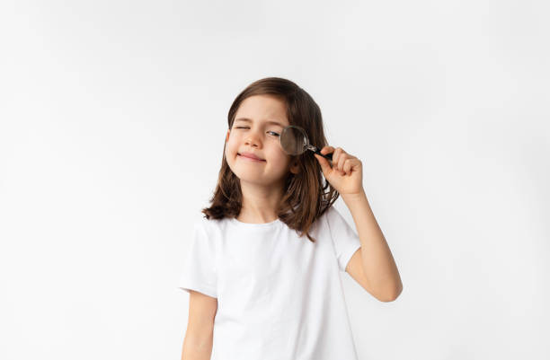 istock 7 Years Old Girl Using Magnifying Glass 1478167706