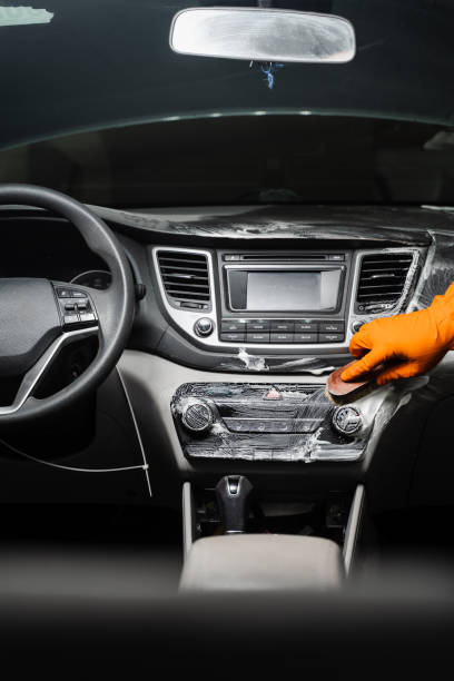 istock Hand car interior drying of dashboard using microfiber in detailing auto service. Cleaner worker dry car interior. 1478171719