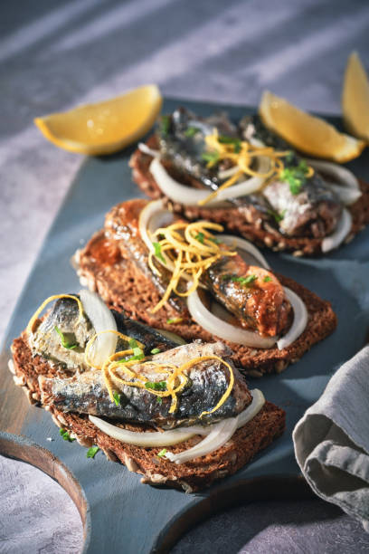 istock Canned Fish - Sardines with Onions and Lemon on Brown Bread 1478174850