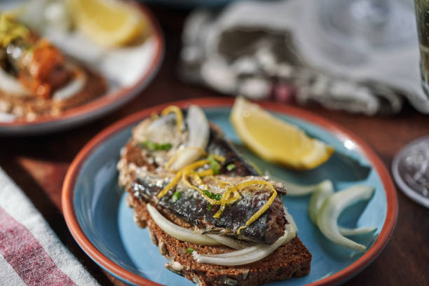 istock Canned Fish - Sardines with Onions and Lemon on Brown Bread 1478174884
