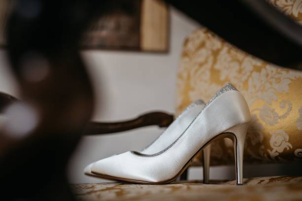 istock Bridal wedding shoes sitting on a chair with a gold damask patterned fabric 1478178662
