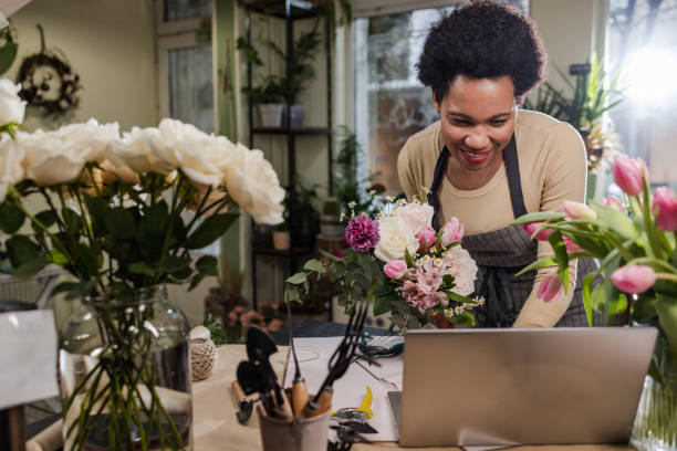istock Flower shop owner is arranging flower bouquets 1478180899