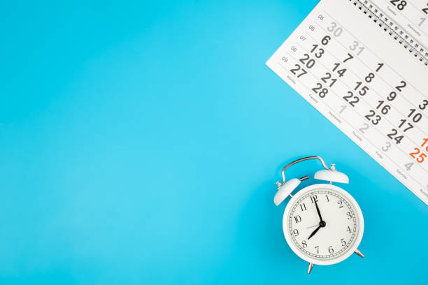 istock Calendar and alarm clock on a blue background, top view, copy space. 1478182976