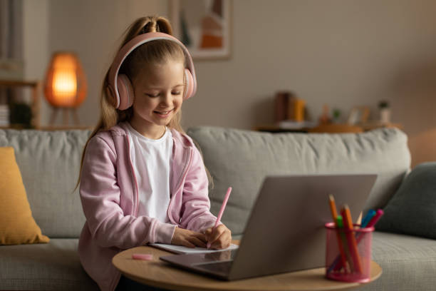 istock Cheerful Girl Taking Notes Learning Online On Laptop At Home 1478183224