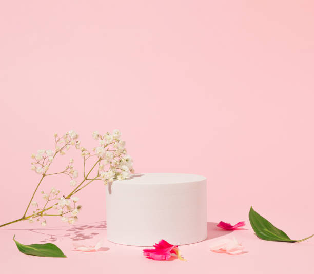 istock Geometric podium platform stand for product presentation and spring flowers on pink background. Mock up scene. Business Concept. Advertisement idea. 1478184798