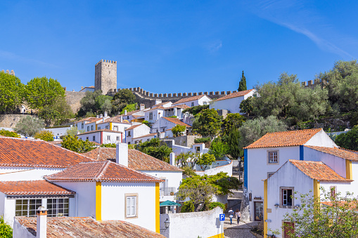 Europe, Portugal, Obidos. Castle wall behind homes in Obidos.