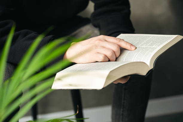 istock Christian man holds holy bible in hands, close up. 1478189169