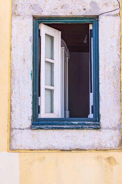 Europe, Portugal, Lisbon. An open window on a building in Lisbon.