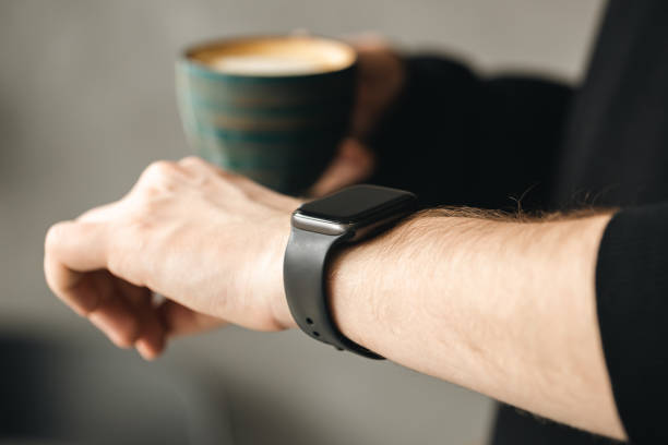 istock A man with coffee checking stylish smart watch, close up. 1478189180