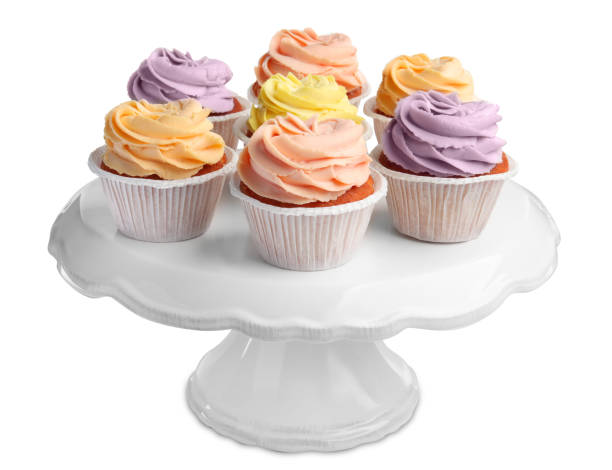 istock Stand with tasty cupcakes on white background 1478192600