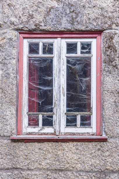 istock Peeling paint on a window in a stone building. 1478194856