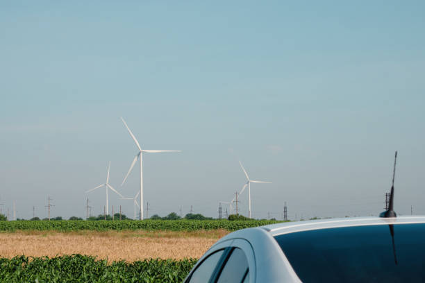 istock Car roof standing on field against distant windmills 1478195343