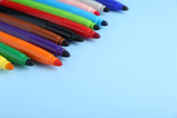 istock Many different colorful markers on light blue background. Space for text 1478198582