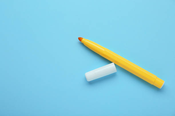 istock Bright yellow marker and cap on light blue background, flat lay. Space for text 1478198884