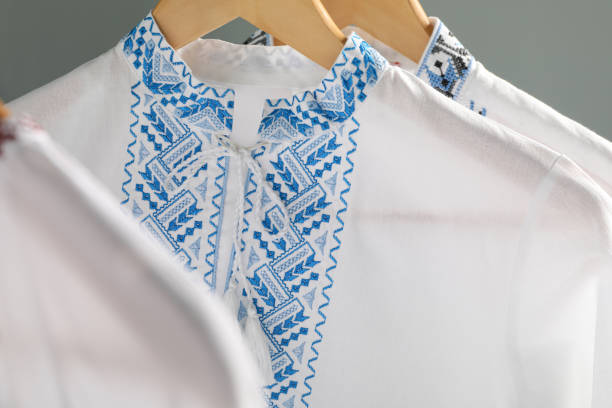 istock Beautiful shirts with different embroidery designs hanging on grey background, closeup. Ukrainian national clothes 1478199573