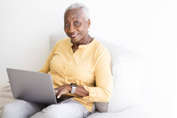 istock Cheerful black woman with laptop looking at camera 1478206305