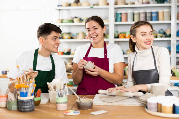 istock Joyous young man and women sculpting handmade cups 1478207142