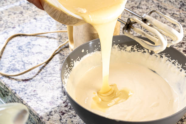 istock Creamy ingredient being poured into the cheesecake pan. 1478213845