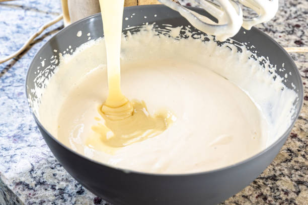 istock Creamy ingredient being poured into the cheesecake pan. 1478213865