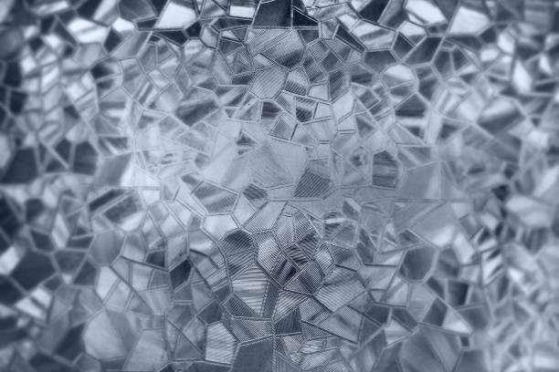 istock Embossed glass background. Corrugated glass monochrome. Refraction of light in a bumpy transparent surface under backlight. The play of white and gray highlights. Black areas. Abstract background. 1478226092