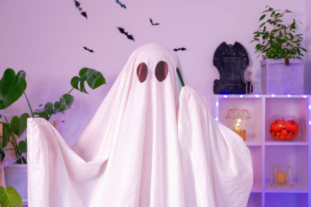 istock The Halloween Ghost uses a mobile phone for calls, congratulations, intimidation. The ghost makes an order from smartphone on Halloween. Funny Halloween concept. 1478226242