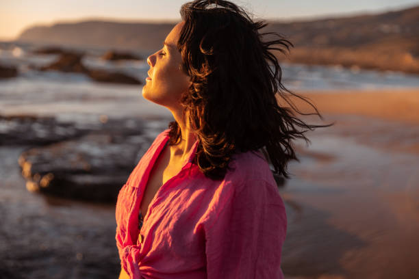 istock Woman enjoying wind near sea 1478227532