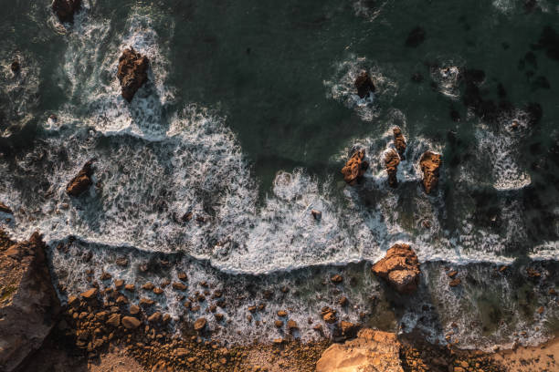 istock Rocks on coast of sea washed with waves 1478227578