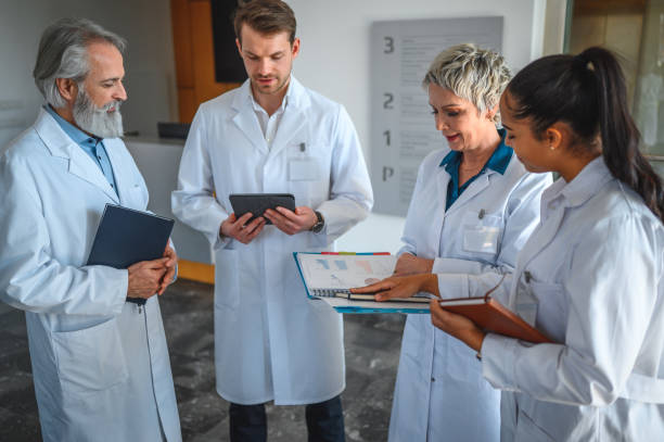 istock Doctors Meet To Discuss Patient in White Lab Coats 1478228567