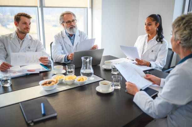 istock Diverse Doctors Wearing Lab Coats are Having a Morning Meeting with Breakfast 1478228629
