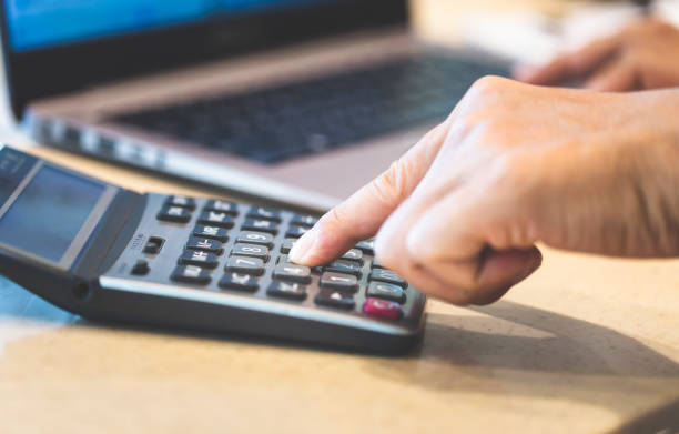 istock Close up of Man hand using calculator and laptop 1478236535