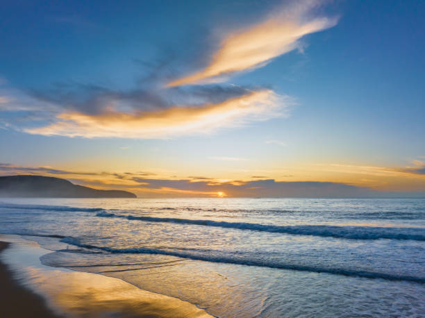 istock Sunrise at the seaside with pretty clouds 1478236784