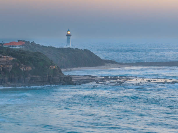 istock Aerial sunrise seascape with lighthouse, high tide and rock platform 1478237681
