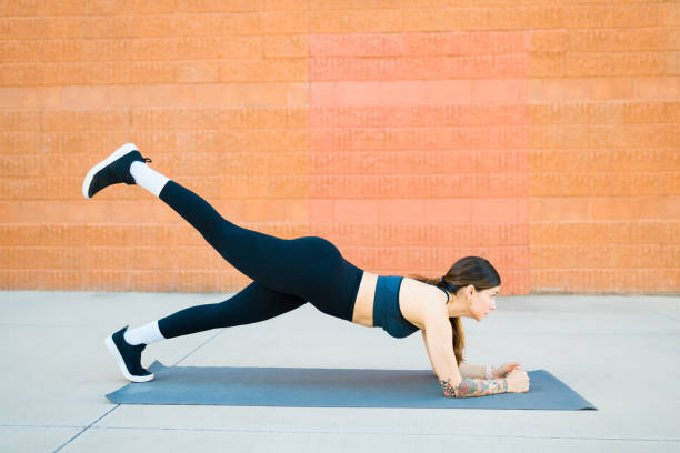 istock Profile of a fit woman exercising outdoors doing planks 1478246958