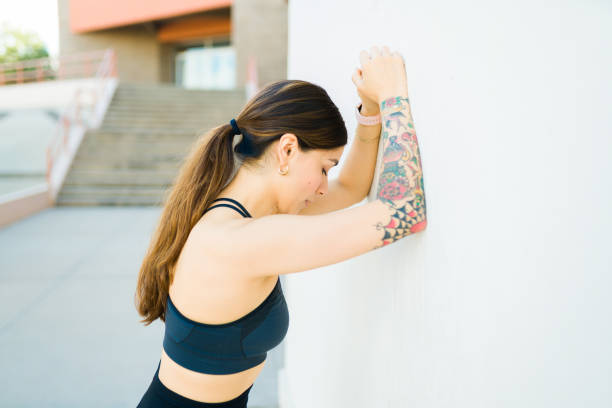istock Exhausted woman resting after running 1478247034
