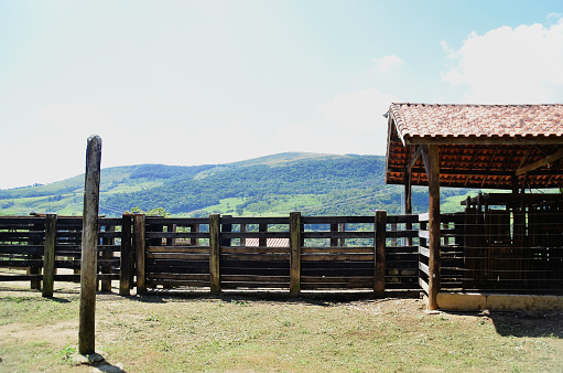 A wooden barnyard on a sunny day in the countryside