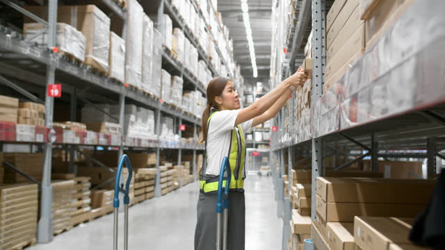 Warehouse workers add products to stock.