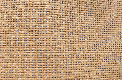 Abstract brown straw hat texture. Texture of straw hat from natural fibers.Top view