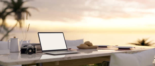 istock Laptop mockup on modern dining table in beautiful outdoor dining space with beautiful ocean view 1478261952