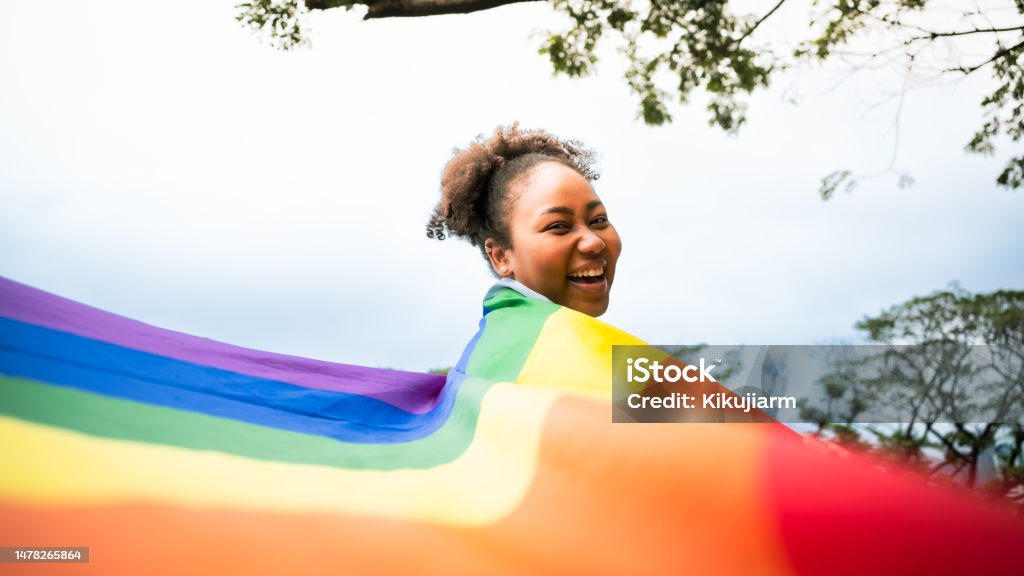 African girls and the power of LGBTQ support. woman and rainbow flag the power of LGBTQ support. LGBTQIA Rights Stock Photo
