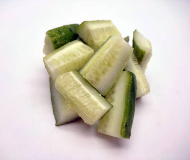 istock Cubed cucumber slices isolated in white background 1478269702