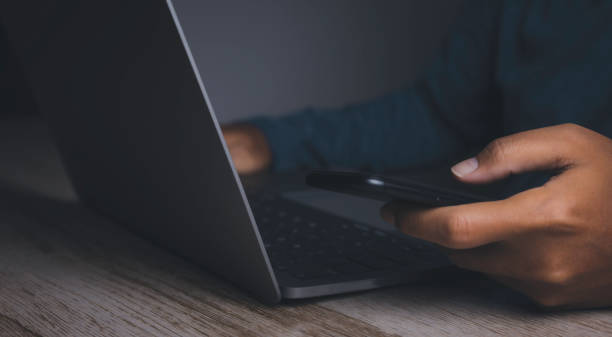 istock Businessman using smartphone with laptop. 1478271494