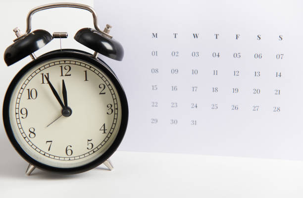 istock Alarm clock and white clean calendar. Busy work reminder, annual leave, project deadline or special event day concept 1478279083