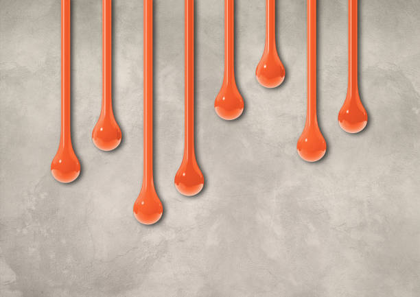 istock Orange ink drops on light concrete wall. Horizontal wallpaper 1478288544