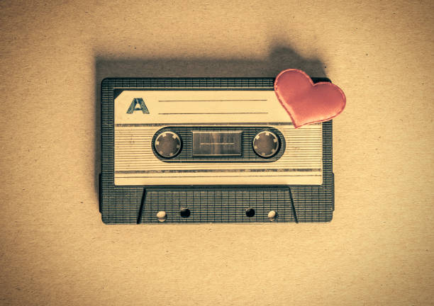 Audio Cassette with a Heart Toned Photo of the Old Audio Tape Cassette with a Red Heart on the Paper closeup mix tape heart stock pictures, royalty-free photos & images