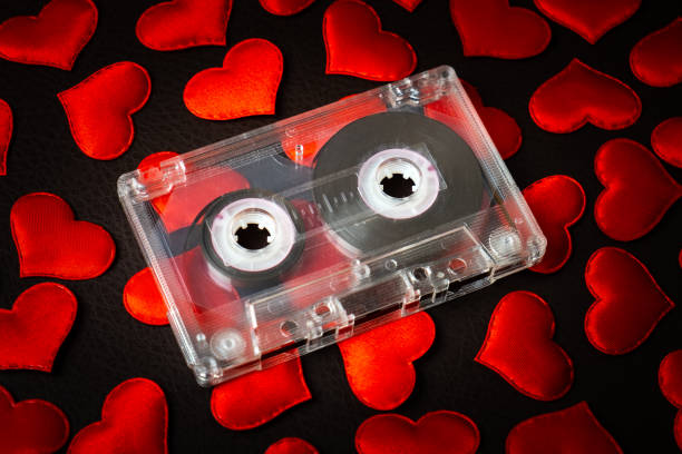 Audio Cassette with a Hearts Audio Tape Cassette on a Scattered Red Hearts closeup mix tape heart stock pictures, royalty-free photos & images