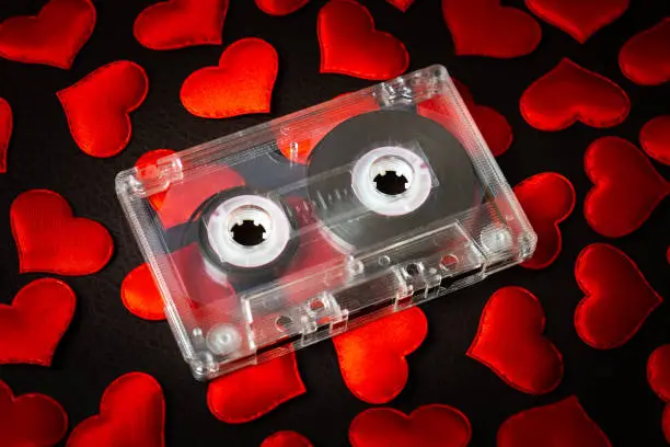 Audio Tape Cassette on a Scattered Red Hearts closeup