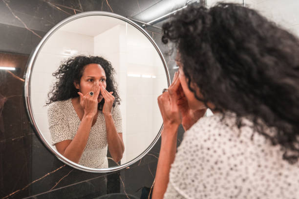 istock Hispanic Female Applying A Face Cream At Home 1478291205